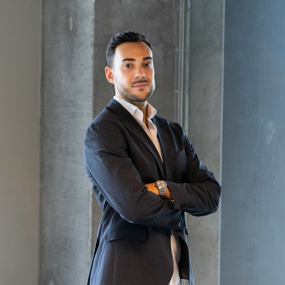 Professional businessman in dark navy suit with confident expression